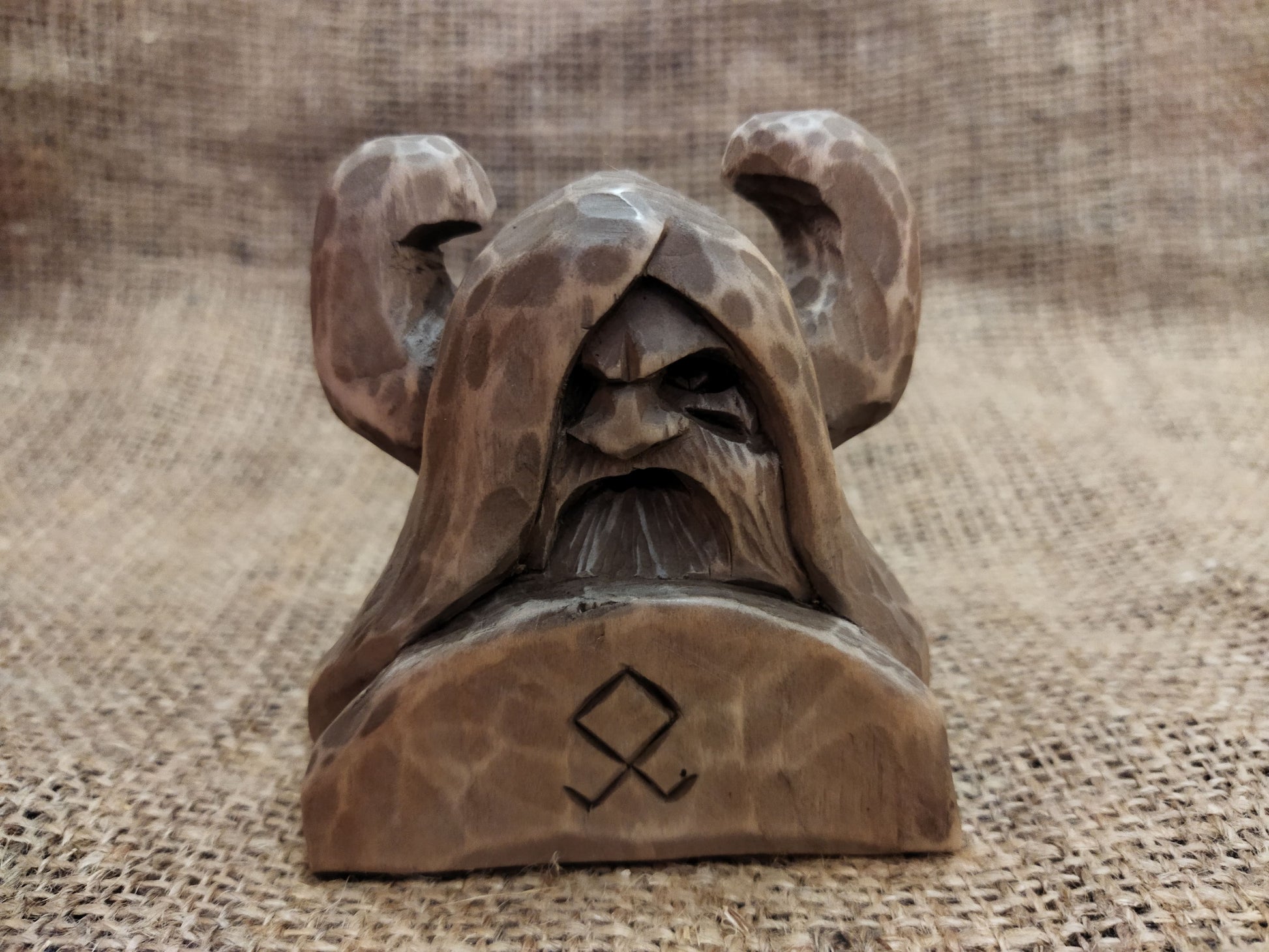 Odin figurine. Handmade statuette of the god Odin. Wood carving.