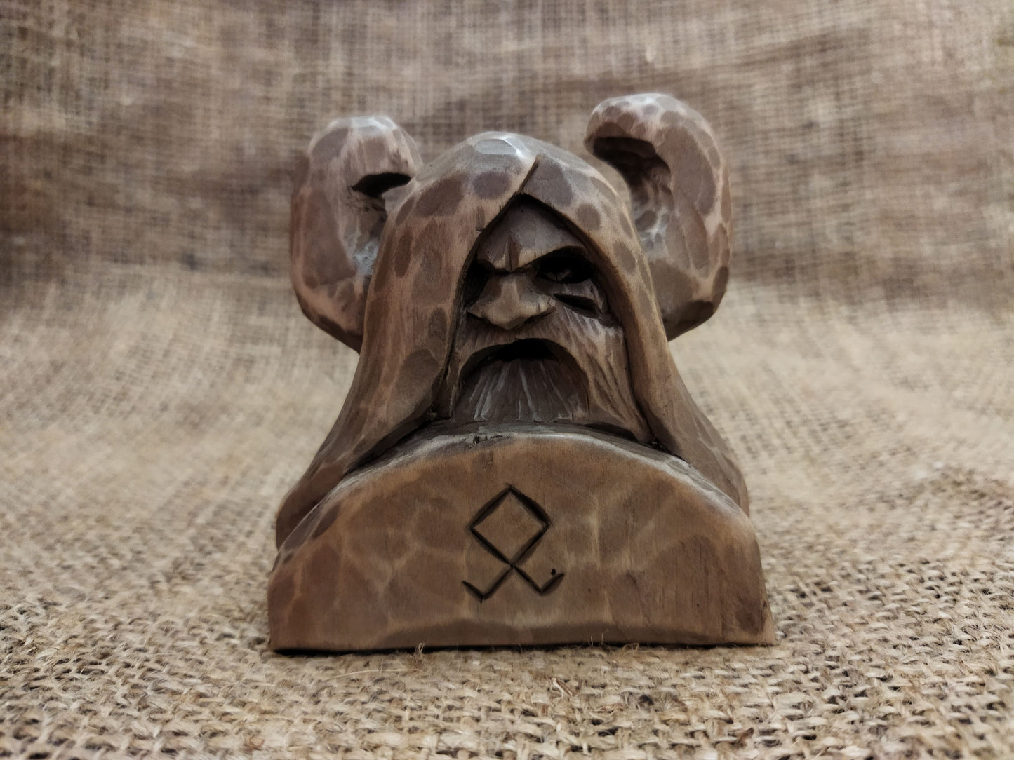 Odin figurine. Handmade statuette of the god Odin. Wood carving.