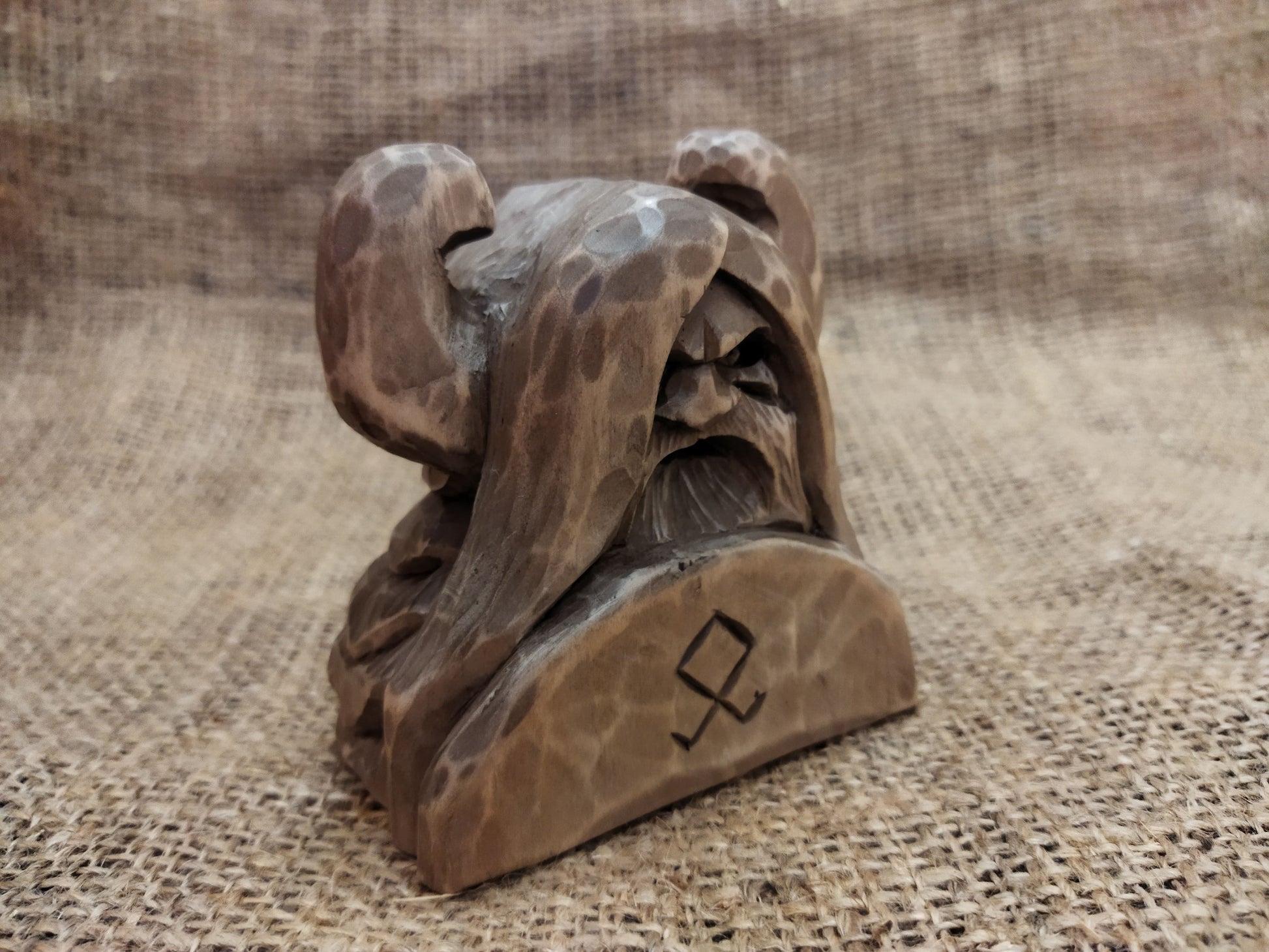 Odin figurine. Handmade statuette of the god Odin. Wood carving.