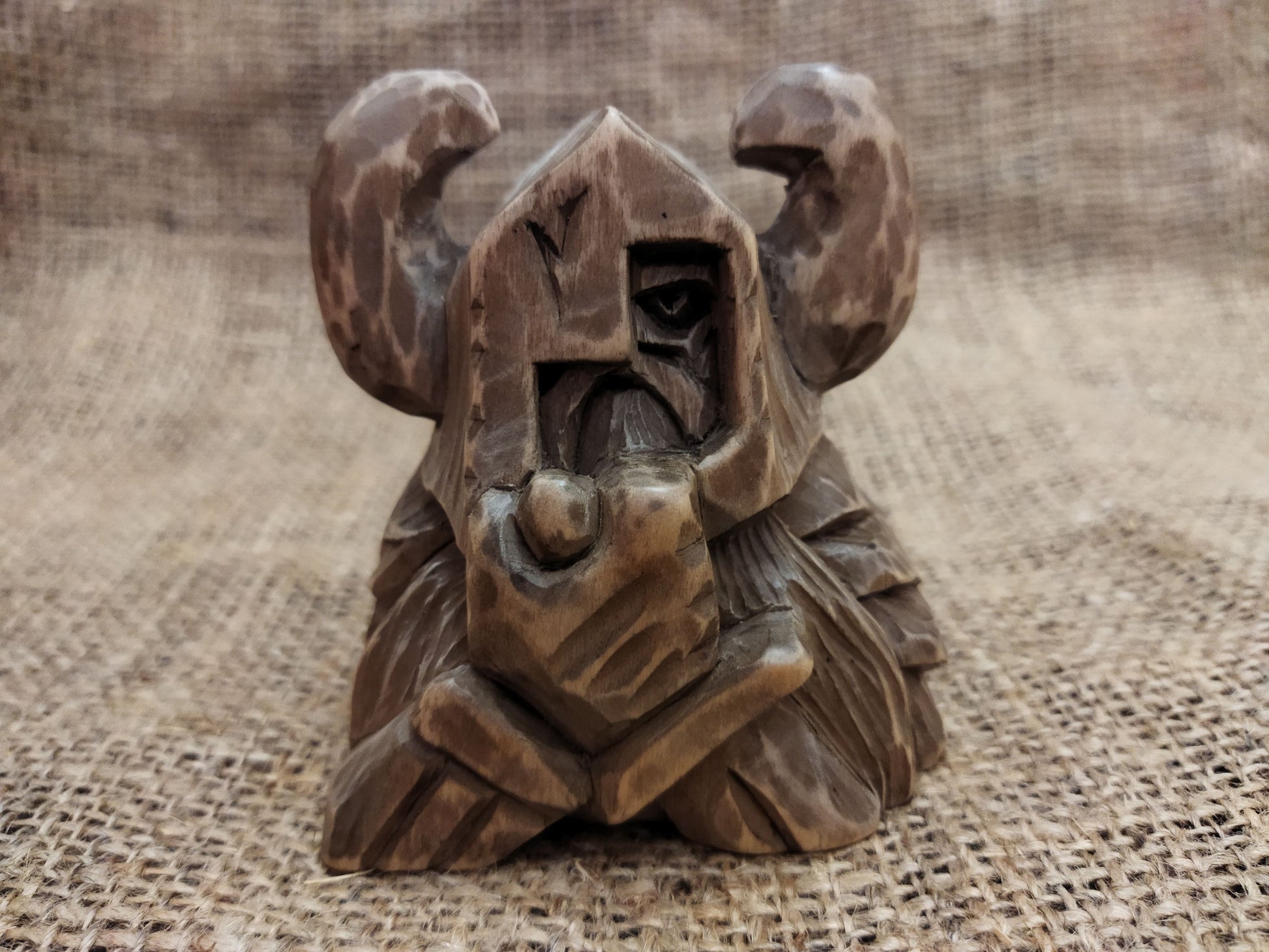 Odin figurine. Handmade statuette of the god Odin. Wood carving.