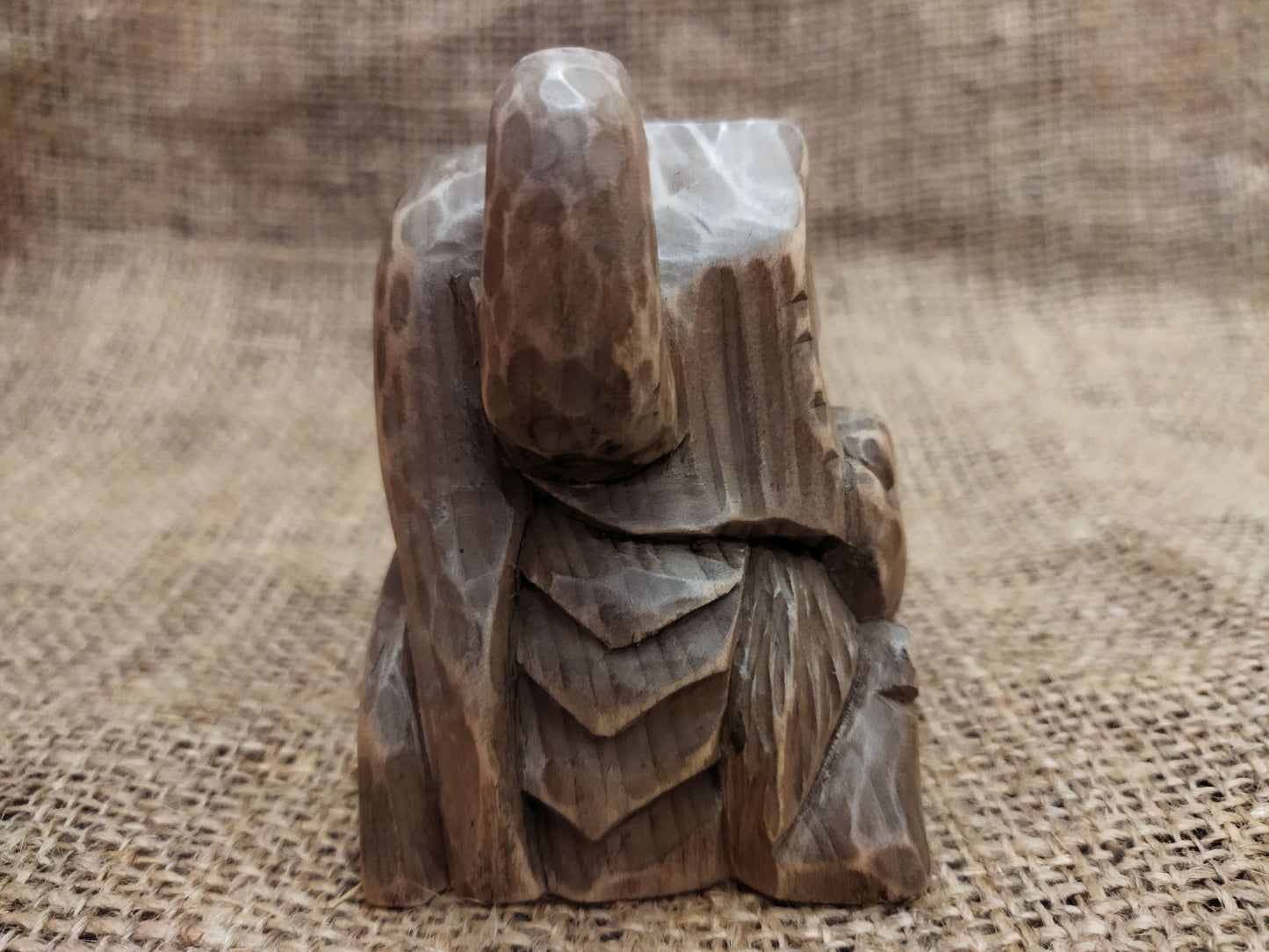 Odin figurine. Handmade statuette of the god Odin. Wood carving.