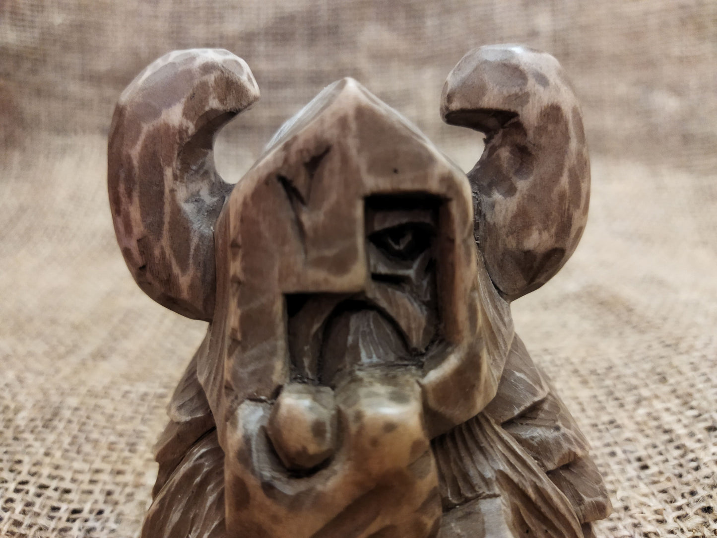 Odin figurine. Handmade statuette of the god Odin. Wood carving.