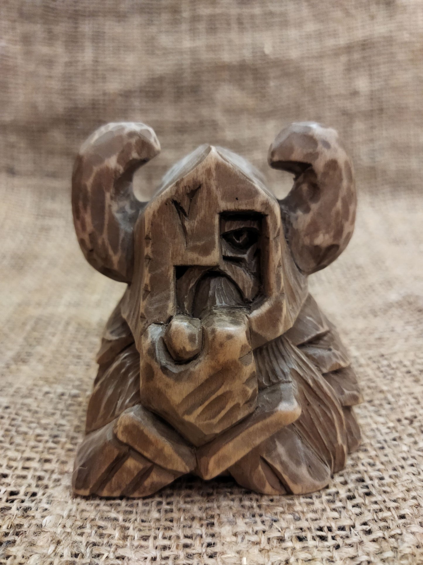 Odin figurine. Handmade statuette of the god Odin. Wood carving.