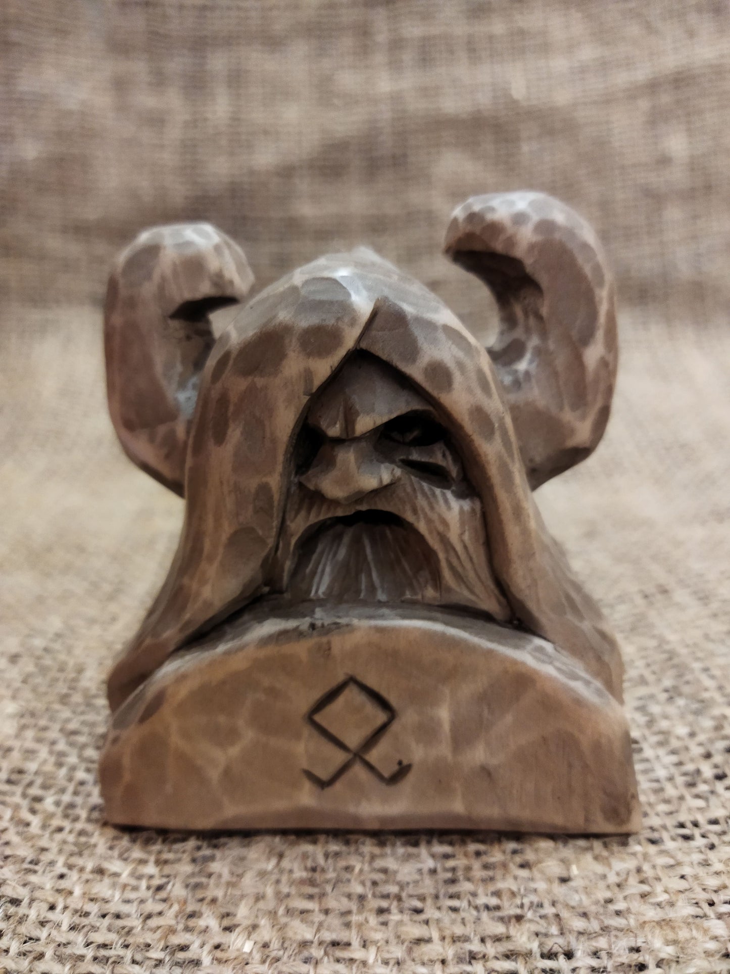 Odin figurine. Handmade statuette of the god Odin. Wood carving.