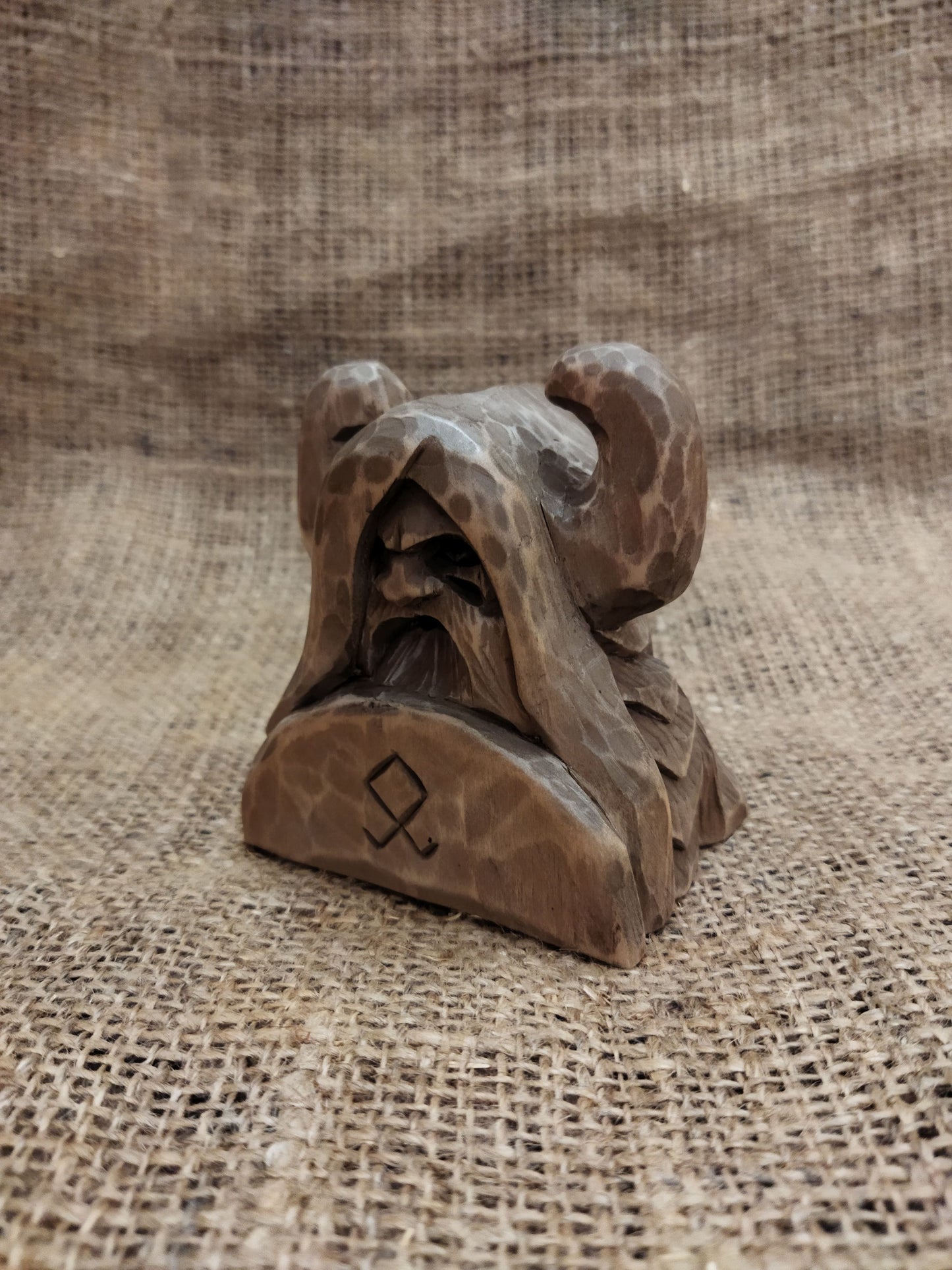 Odin figurine. Handmade statuette of the god Odin. Wood carving.