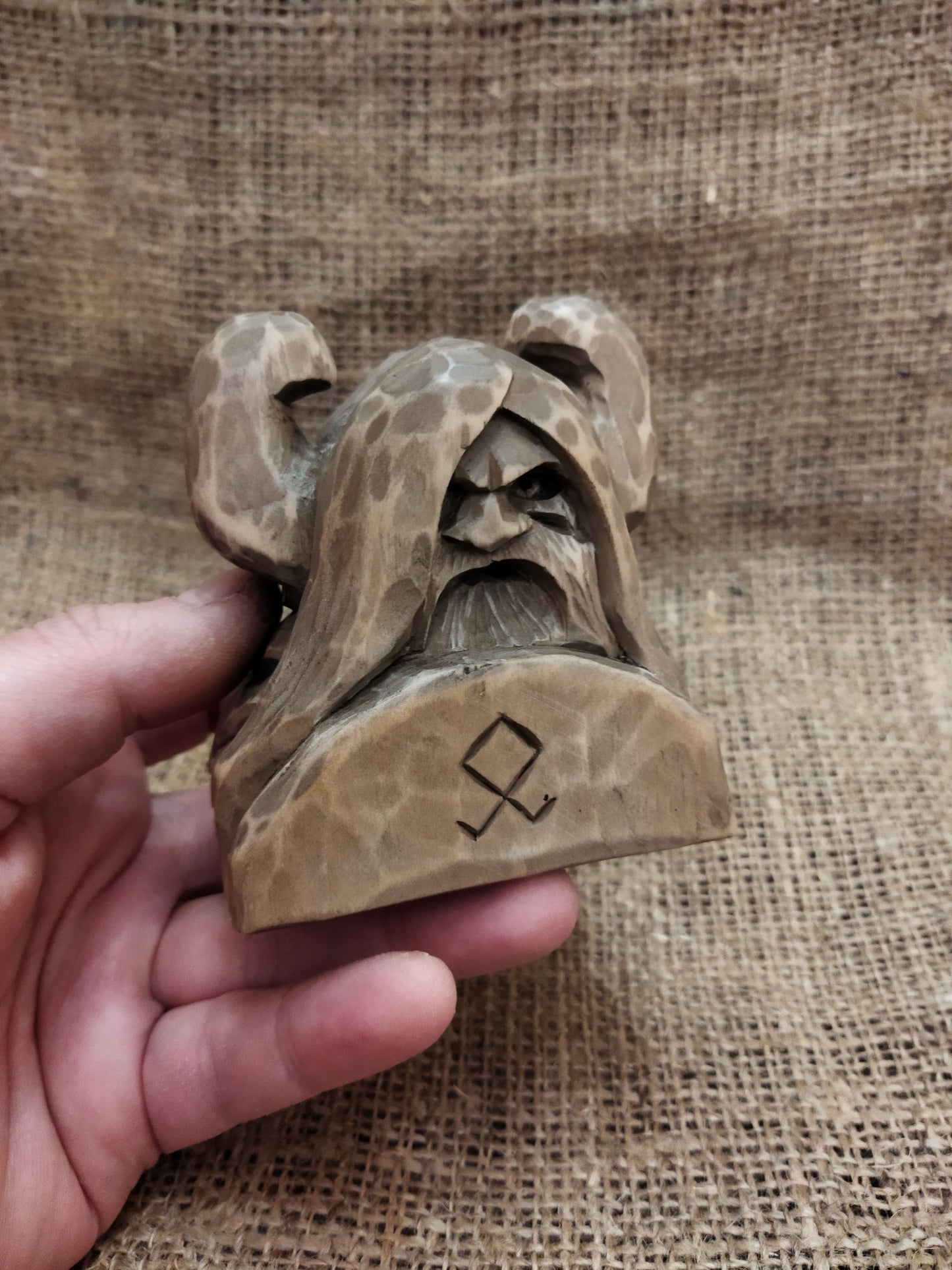 Odin figurine. Handmade statuette of the god Odin. Wood carving.