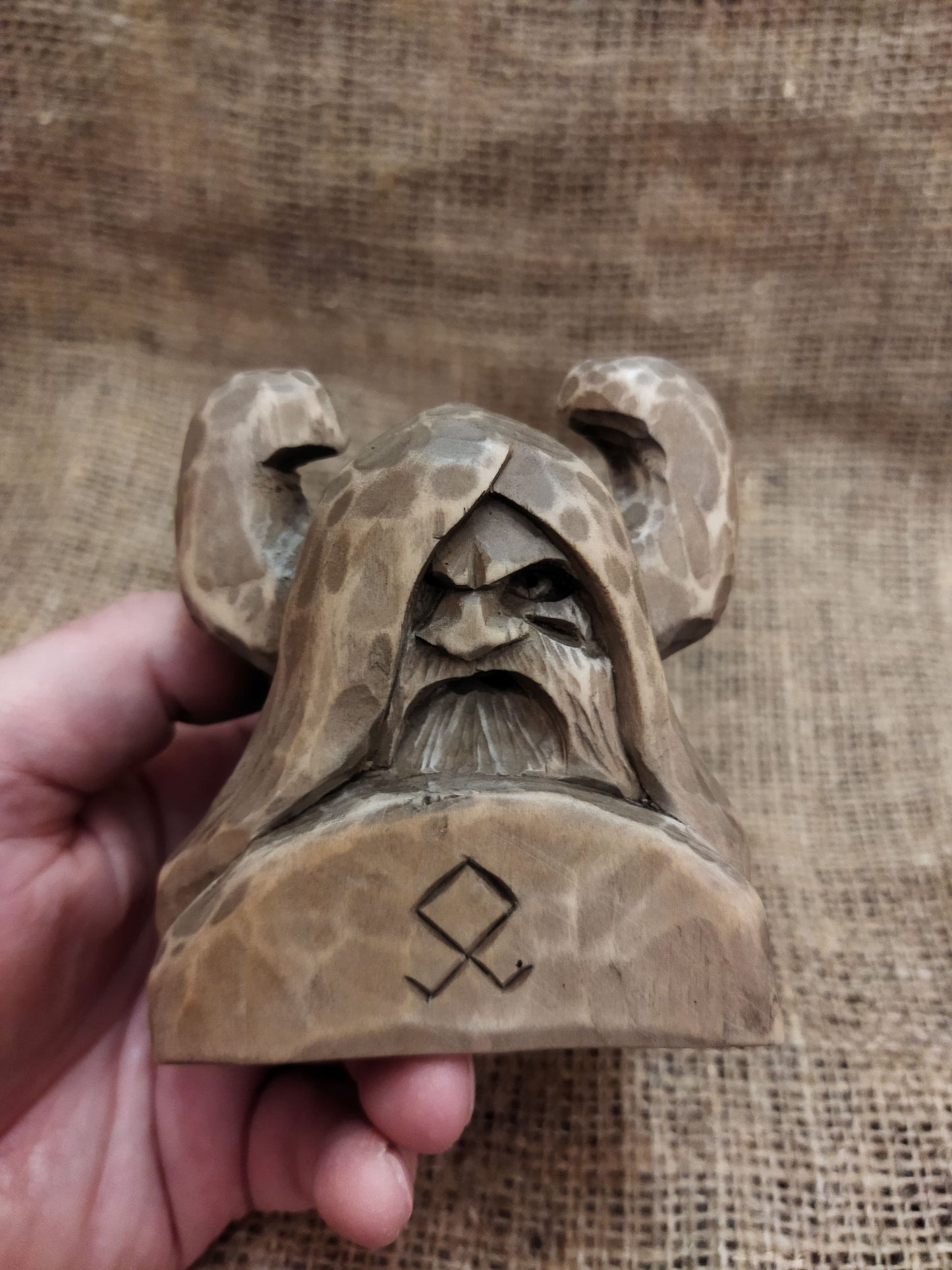 Odin figurine. Handmade statuette of the god Odin. Wood carving.